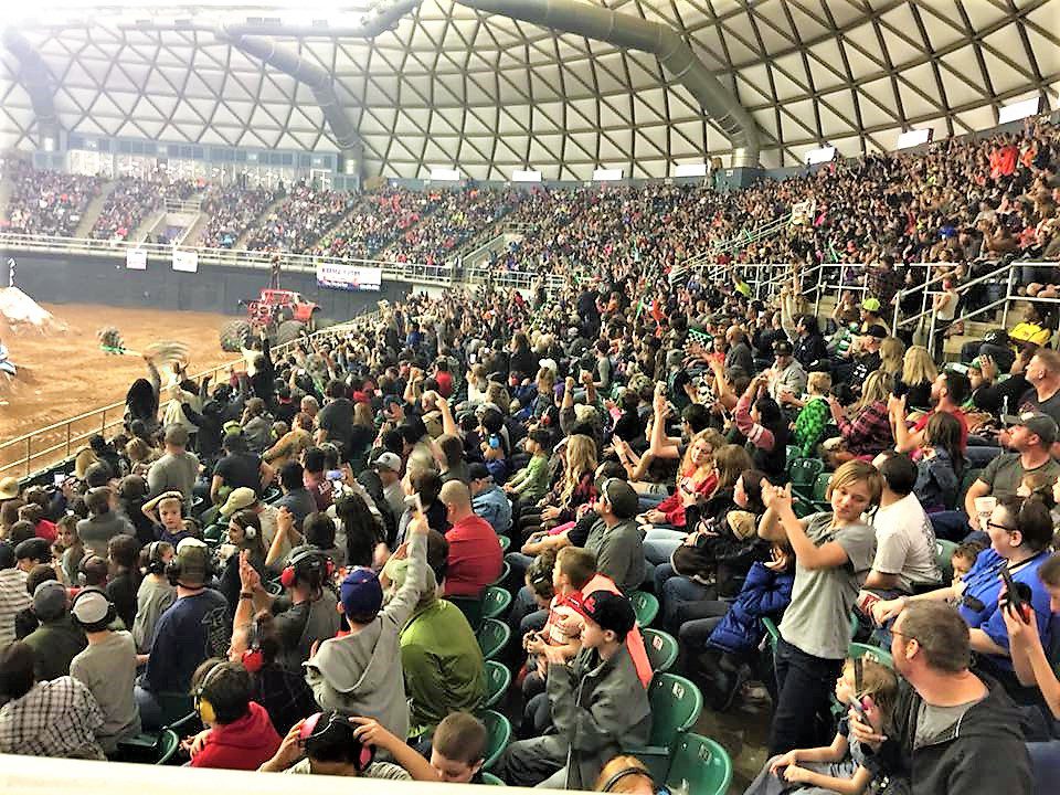 A crowd of people sitting in stadium seats.