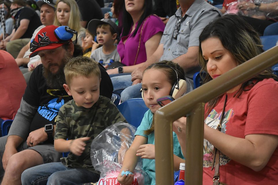 A group of people sitting in the stands at an event.