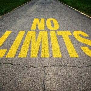 No Limits" painted on a paved road.