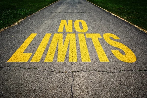 No Limits" painted on a paved road.
